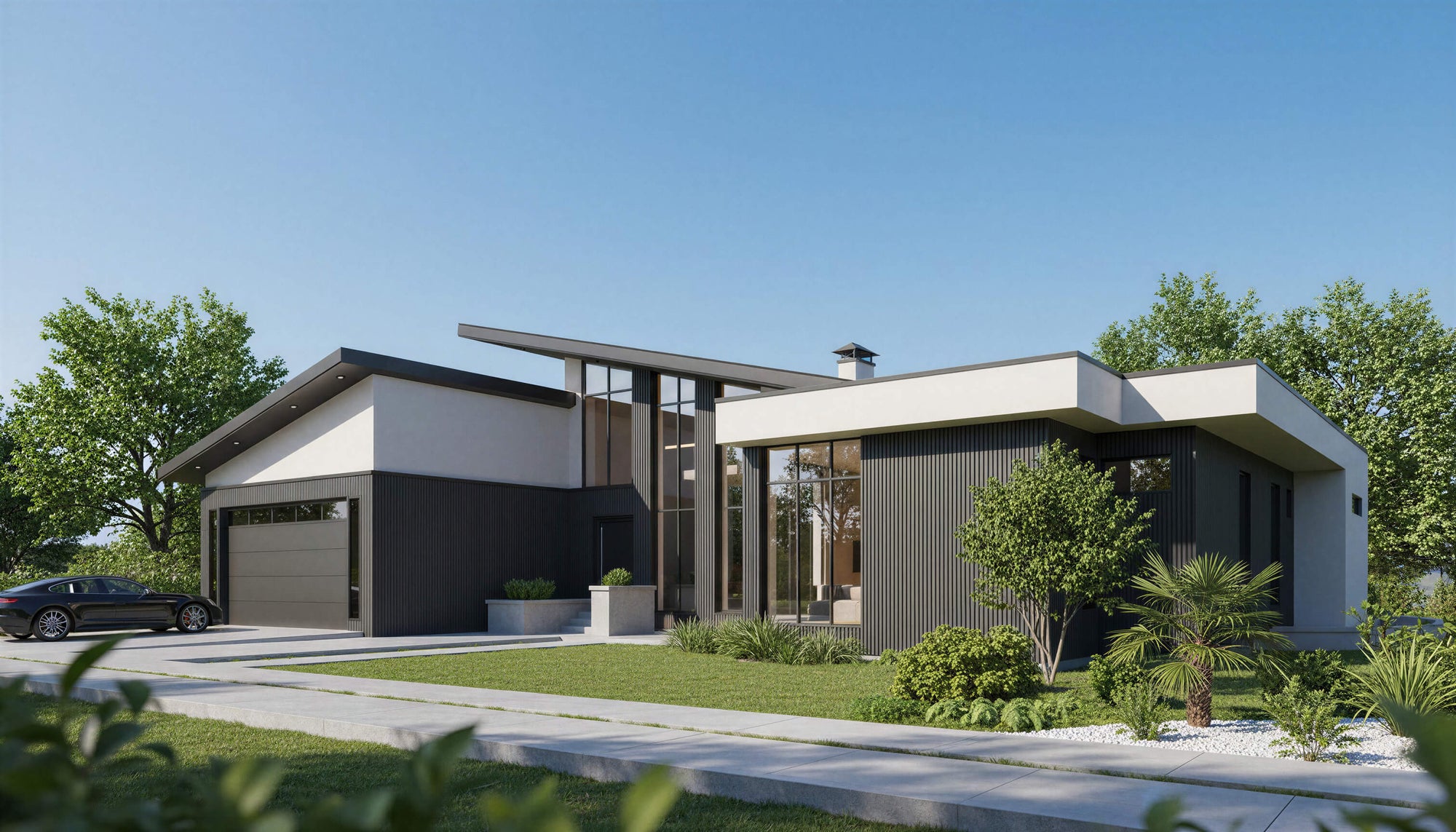 Modern house with a driveway and trees on a clear day