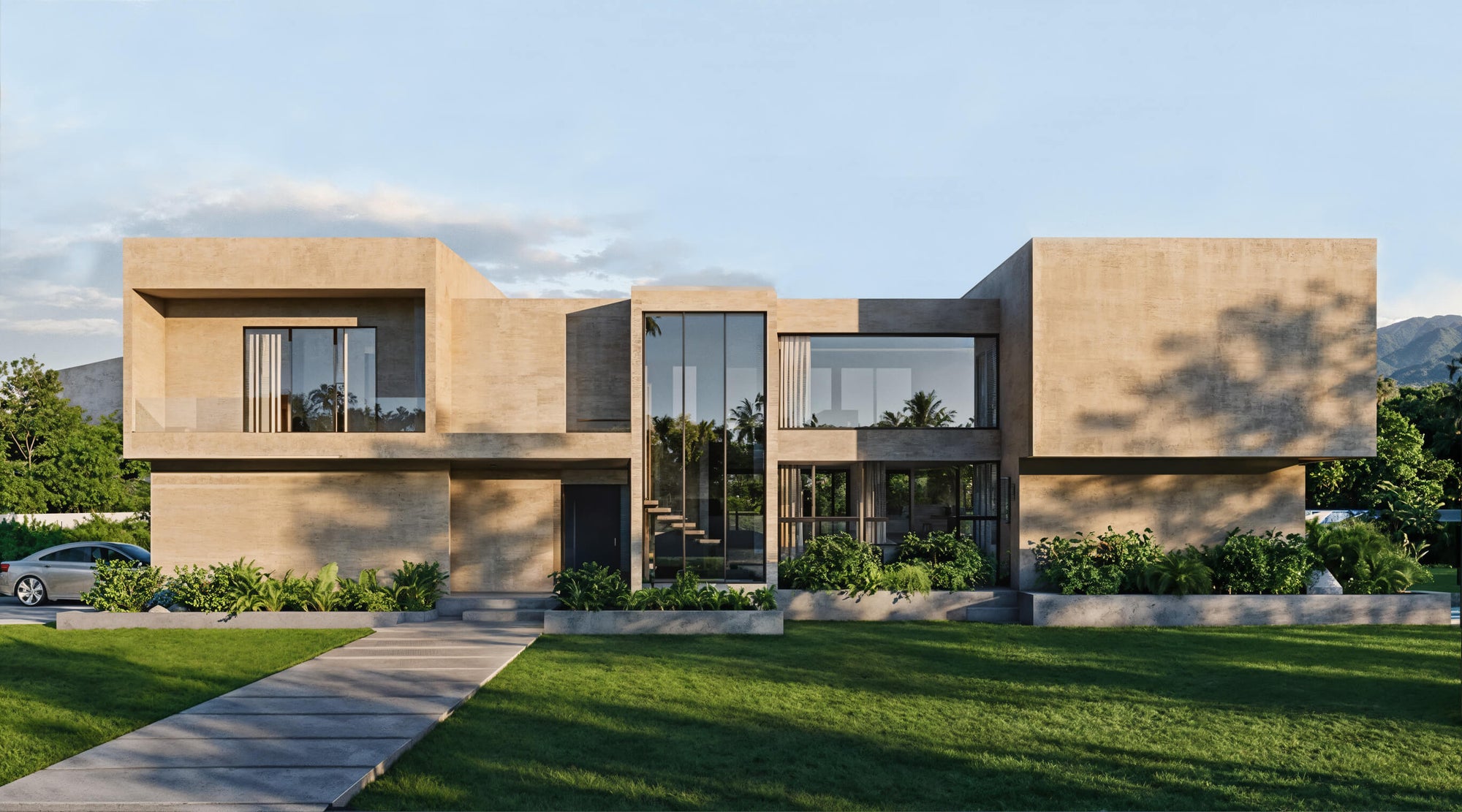 Modern house with beige exterior and glass windows, surrounded by greenery.