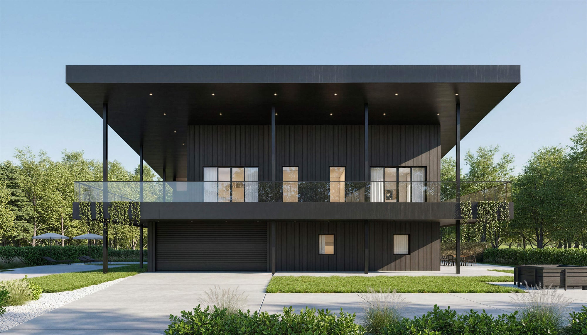 Modern black house with glass windows surrounded by greenery