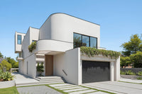 Exterior view of CASA CLARUS sculptural contemporary house plan with curved volumes and cylindrical forms by Arcus Dein